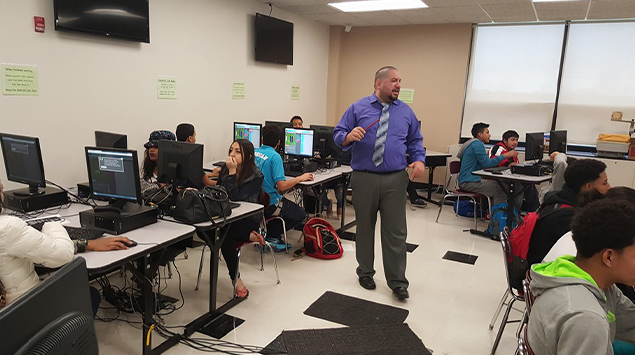Instructor teaching students in computer lab