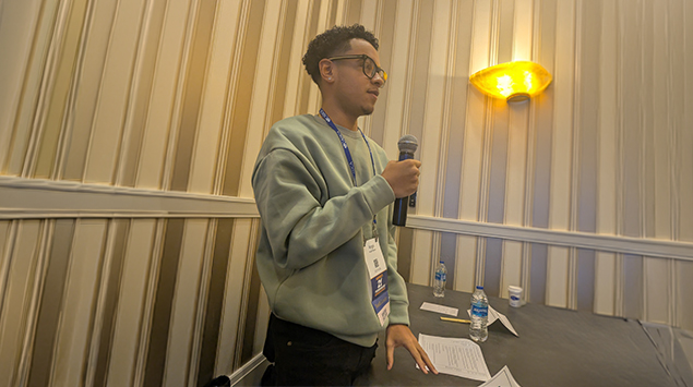 Student speaking into a microphone