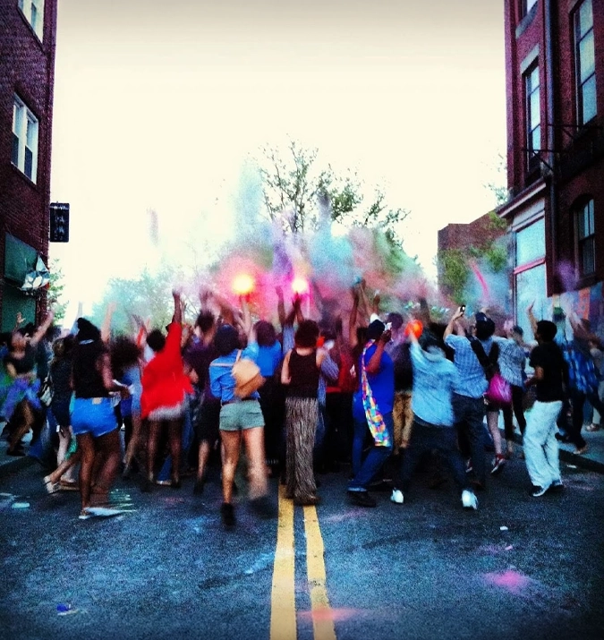 Crowd celebrating with colorful powder